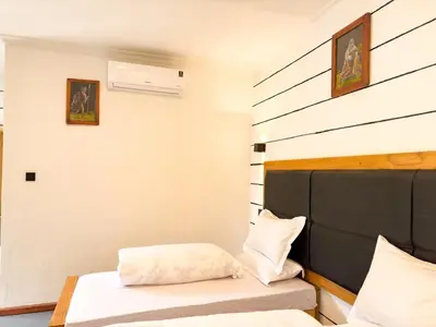 a bedroom with a bed and a wall at Njiro Climax in Arusha