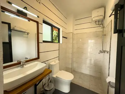 a bathroom with a sink and a toilet and a mirror at Njiro Climax in Arusha