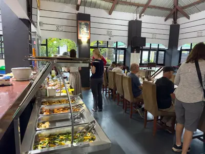 a group of people sitting at a buffet in a restaurant at Njiro Climax in Arusha