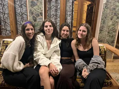 a group of four women sitting on a couch at Starehe Villa in Arusha
