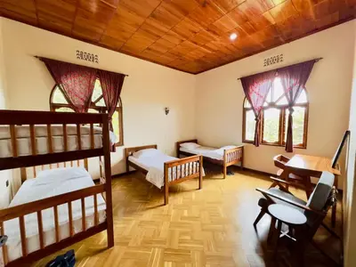 a room with two bunk beds and two windows at Starehe Villa in Arusha