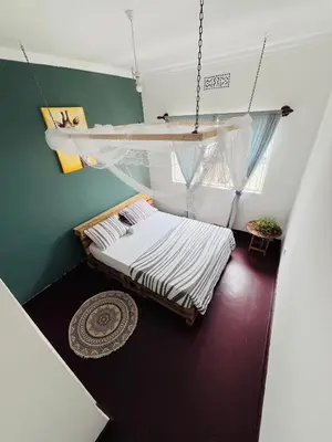 a room with a bed and a swing at COZY NYUMBA in Arusha