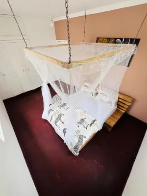 a chandelier hanging from a ceiling in a room at COZY NYUMBA in Arusha