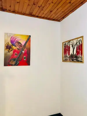 two paintings on a wall in a room at COZY NYUMBA in Arusha