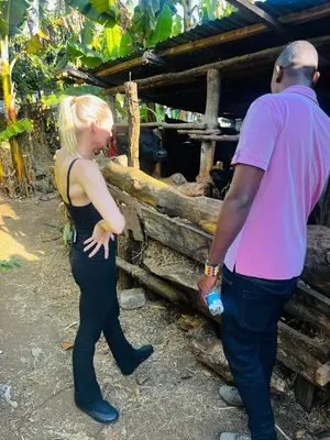 a man and a woman standing in front of a barn at Meleji House in Arusha