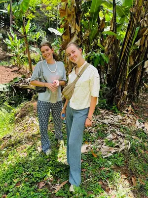 two women standing next to each other in a forest at Meleji House in Arusha