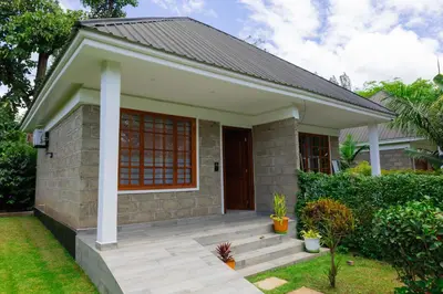 a small house with a porch at Kerama Silent Lodge in Arusha