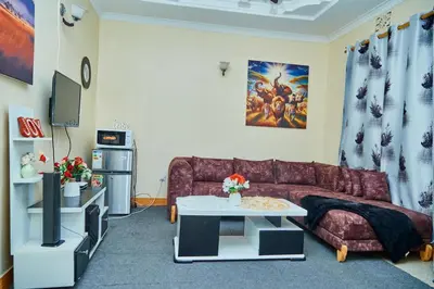 a living room with a couch and a table at Mella home Arusha in Arusha