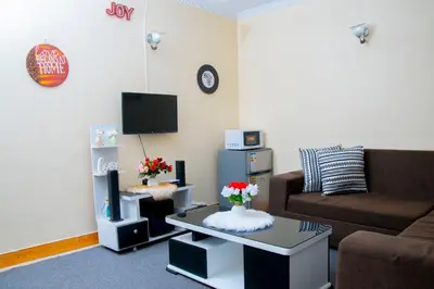 a living room with a couch and a coffee table at Mella home Arusha in Marombosa