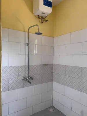 a bathroom with a shower with a shower head at Karibu Africa Home in Moshi