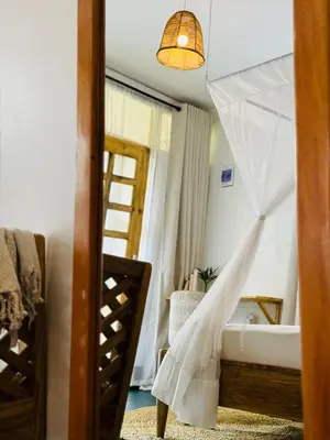 a bedroom with a bed with a wedding veil at Karibu Africa Home in Moshi