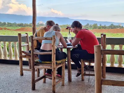 a group of people sitting at a table at Hill View Garden Hotel in Moshi