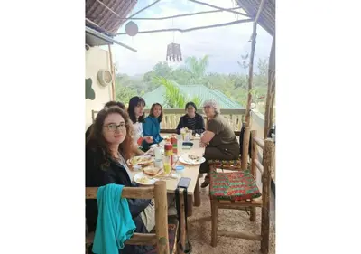 a group of people sitting at a table at Hill View Garden Hotel in Moshi