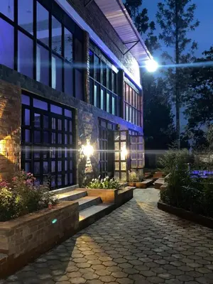 a building with stairs leading to a courtyard at night at Jabulani Private Villas in Arusha