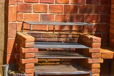 a brick wall with a bench in front of it at Jabulani Private Villas in Arusha