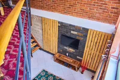 an image of a brick fireplace with a tv at Jabulani Private Villas in Arusha