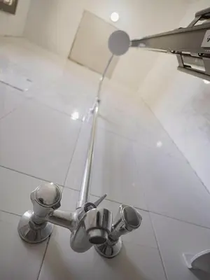 a bathroom with a sink and a faucet at Home Feeling Kilimanjaro in Moshi