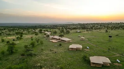 an aerial view of a group of huts in a field at Serengeti Malaika Luxury Camp in Serengeti National Park