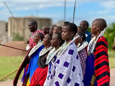 a group of people standing in a line at Maasai Eco Boma & Lodge - Experience Maasai Culture in Makuyuni