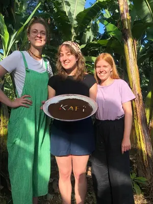 a group of three women standing in front of a tree at Karibu Eco-Hostel Arusha in Arusha