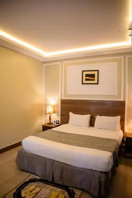 a bedroom with a large bed in a room at Greenside Hotel in Arusha