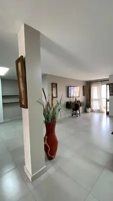 a lobby with a vase with a plant in it at Imbasa House in Arusha