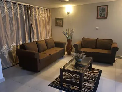 a living room with a couch and a coffee table at Imbasa House in Arusha