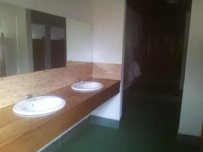 a bathroom with two sinks and a large mirror at Panorama Safari Camp in Mto wa Mbu