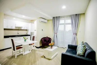 a living room with a couch and a table at Snow View Rau Apartments in Moshi