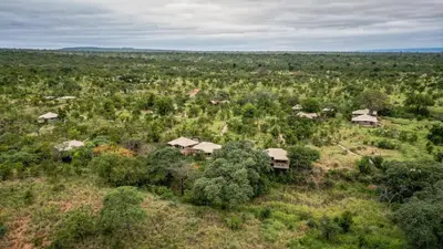 an aerial view of a house in a field with trees at Olkeri Camp in Olmotoni
