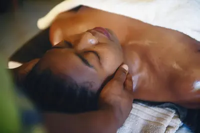 a man laying on a bed with his eyes closed at Rivertrees Country Inn in Usa River