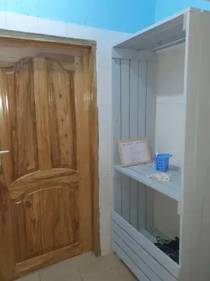 a closet with a wooden door in a room at Sinana country Home-Backpackers Stay in Kibongoto