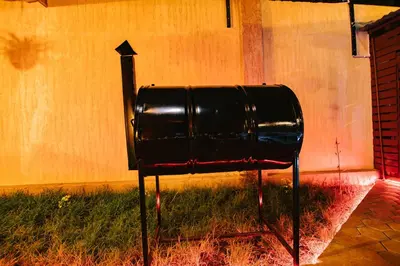 a black trash can sitting next to a wall at THE WOODEN HOUSE in Msaranga