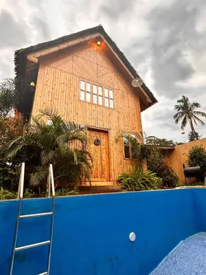 a large wooden house with a ladder in front of it at THE WOODEN HOUSE in Msaranga