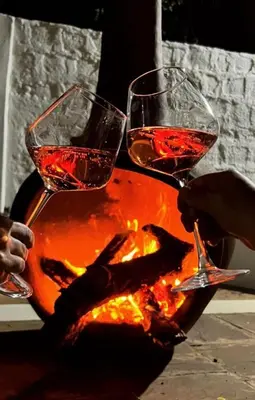 two glasses of wine sitting on top of a fire at The Kilimanjaro Villa in Moshi