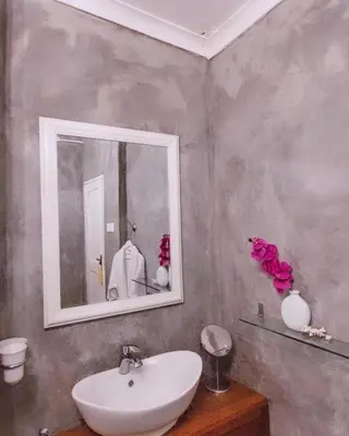 a bathroom with a sink and a mirror at The Kilimanjaro Villa in Moshi