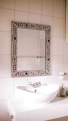 a bathroom with a sink and a mirror at The Kilimanjaro Villa in Moshi