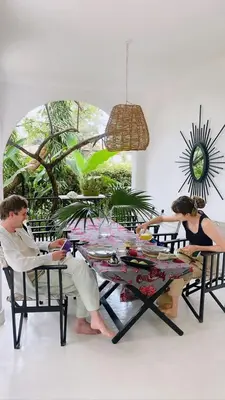 a man and a woman sitting at a table at The Kilimanjaro Villa in Moshi