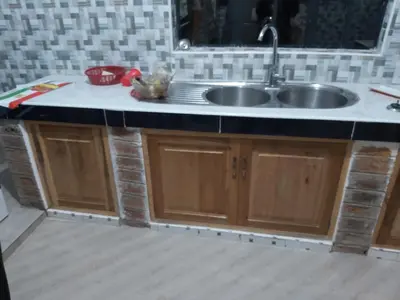 a kitchen with a sink and a counter at Mama Aziz Homestay in Arusha