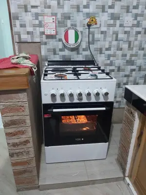 a stove in a kitchen with a oven at Mama Aziz Homestay in Arusha