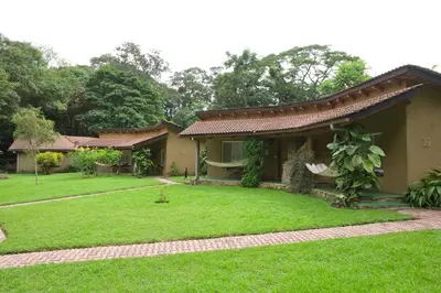 a house with a green lawn in front of it at Dik Dik Hotel in Arusha