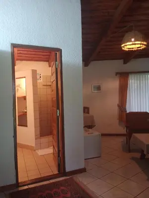 a room with a door leading to a bathroom at Dik Dik Hotel in Arusha