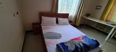 a bed in a small room with at Triple D's in Moshi