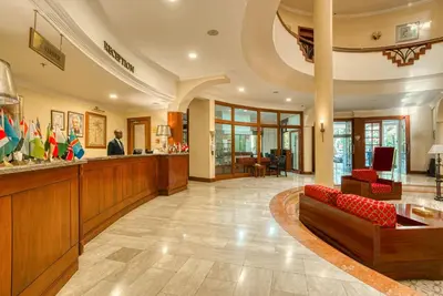 a lobby of a hotel with a reception desk and a lobby at Kibo Palace Hotel Arusha in Arusha