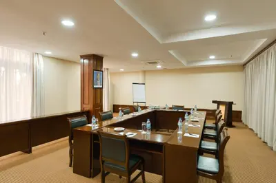 a conference room with a long table and chairs at Kibo Palace Hotel Arusha in Arusha