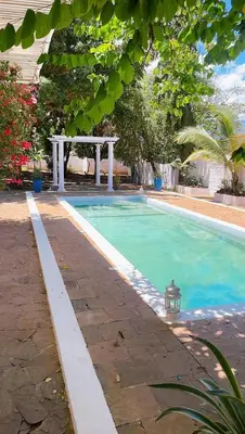 a swimming pool in a yard with at Kilimanjaro Twin Rooms Queen Beds in Moshi