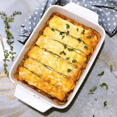 a casserole dish filled with a cheesyasserole with cheese at Kilimanjaro Twin Rooms Queen Beds in Moshi