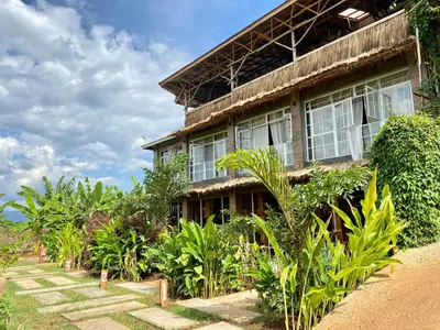 a building with a bunch of plants in front of it at Mount Kilimanjaro 360 view Cottage in Uru