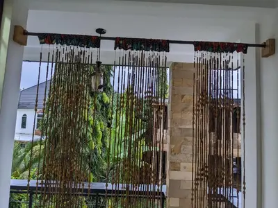 a window with bamboo curtains in a room at Mama Africa Killi Villa in Moshi