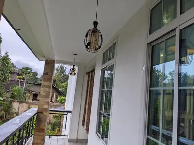 a porch with glass doors and a pendant light at Mama Africa Killi Villa in Moshi